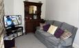 Lounge at Llwyn Beuno with seating for 5 with a Smart TV with wifi coverage throughout the cottage