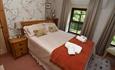 Bedroom at Llwyn Beuno, with wardrobe, dressing table and bedside tables