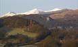 Dolwyddelan castle with snow-capped Snowdon in the background