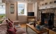 Lounge at Arallt Holiday Cottage on the Llyn Peninsula, woodburner and stunning views