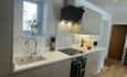 Kitchen with gloss units, quartz worktops & Bosch appliances.