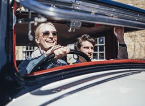 Couple driving a classic car