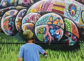 Man using spray can to create artwork