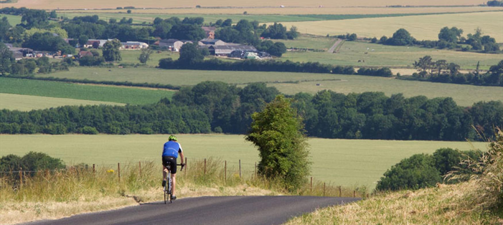 Cyclist going downhill with countryside views