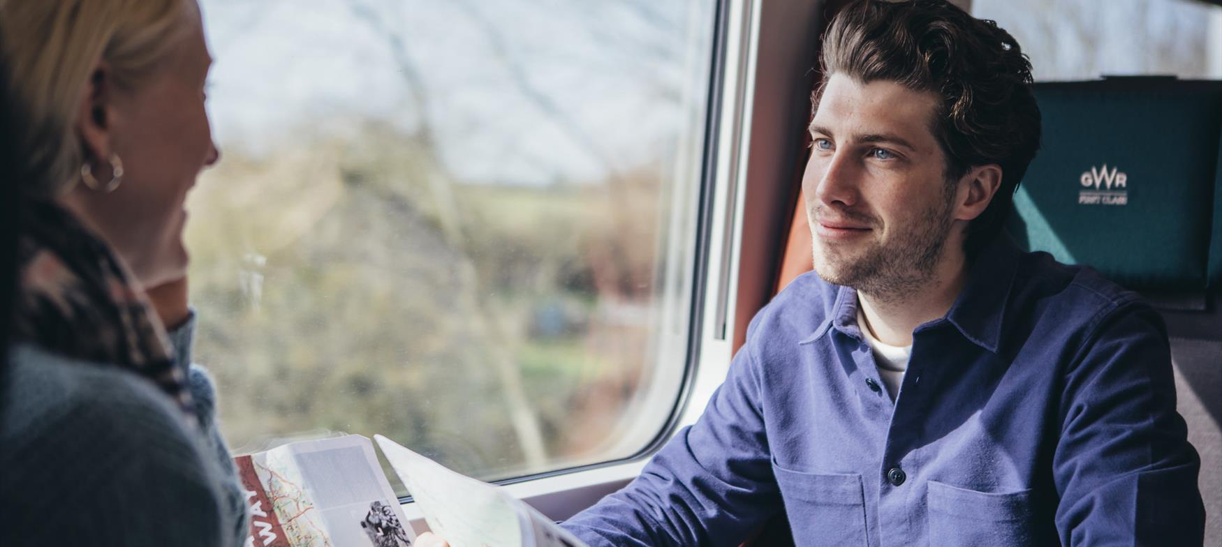 Man and woman on train looking at map