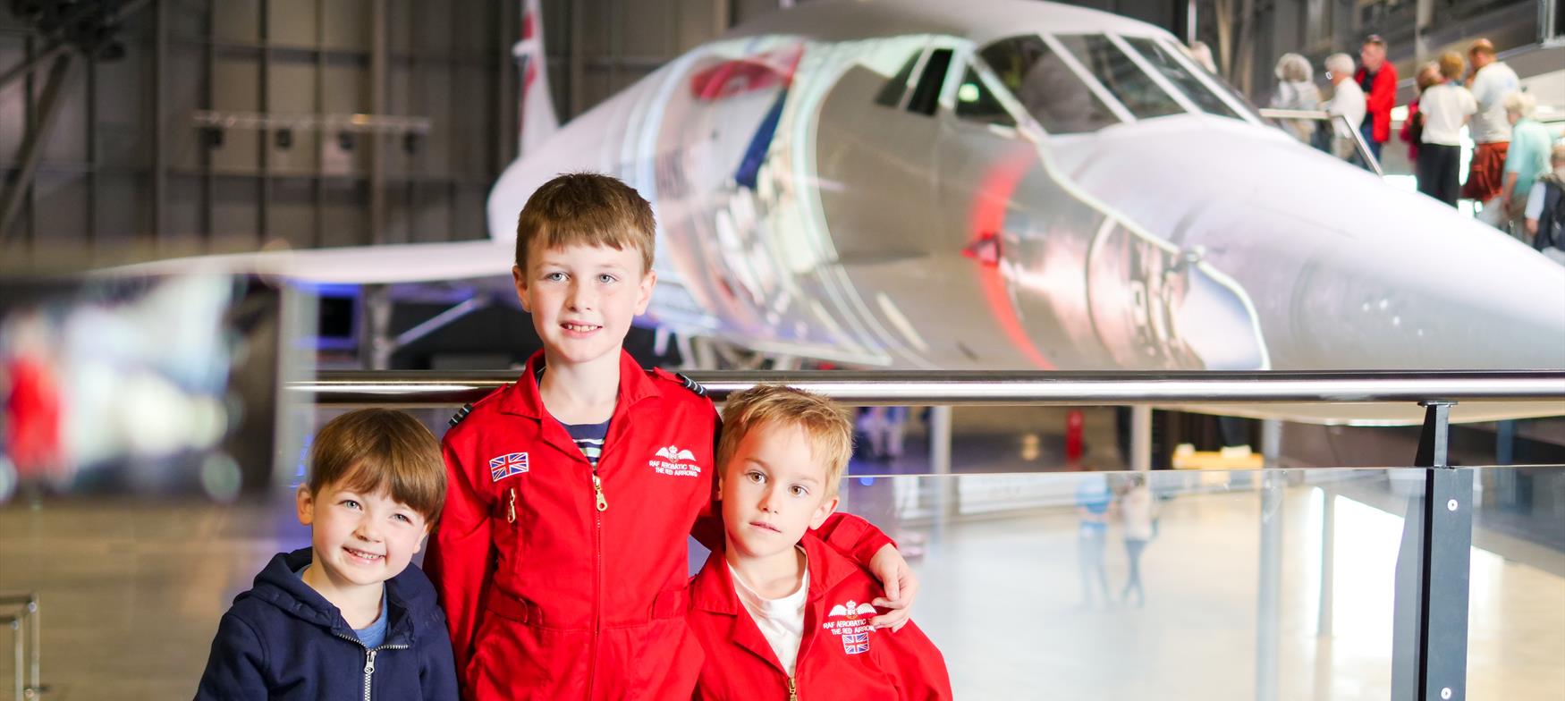 children in front of plane