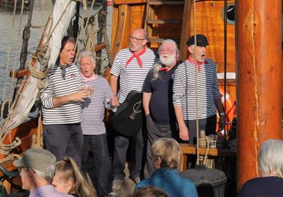 A group of singers performing on The Matthew