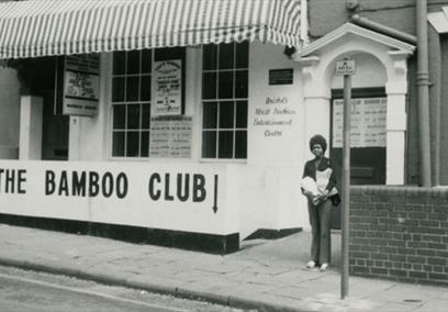 A black and white image of a shop with The Bamboo Club written on the front