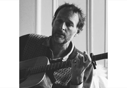Alasdiar Roberts playing his guitar