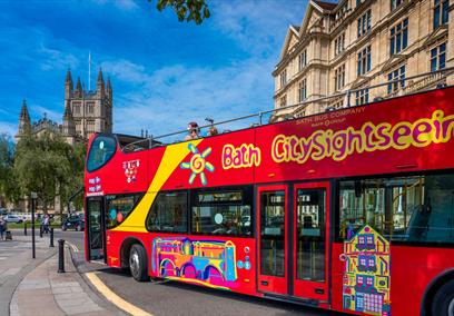 Red open-top tour bus in Bath