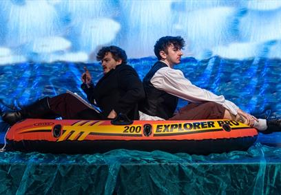 2 people in an inflatable life raft