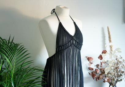 A black macrame dress on a mannequin