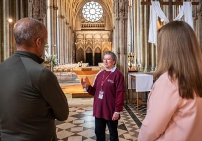 2 people standing with a volunteer from Bristol Cathedral