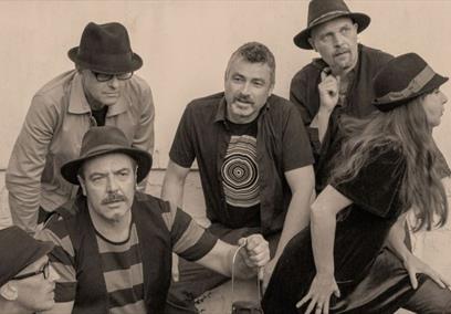 Black and white publicity photograph of the Mad Dog Mcrea band members striking different poses