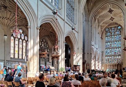 People sat in Bath Abbey listening to a music act