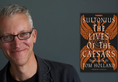 A man smiling against a black background alongside a book cover.