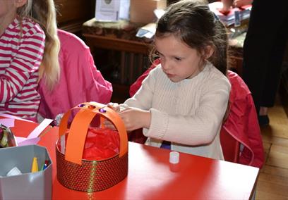 Little girl taking part in a craft activity at Windsor Castle