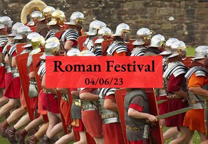 A group of men dressed in Roman centurion outfits marching along a field with the text 'Roman Festival 4/6/23' overlaid.