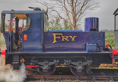 Blue locomotive with gold writing on it