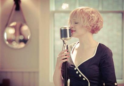 A woman singing into a microphone