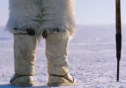An eskimo stood in the snow