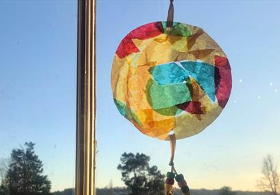 A photo of a suncatcher held against a window
