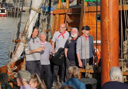 Five men singing sea shanties on Matthew in Bristol