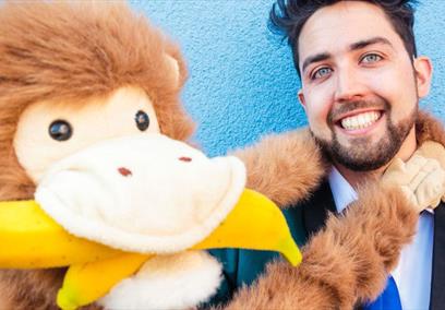 Marky Jay holding a monkey puppet