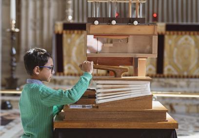 A young boy playing with an interactive exhibit