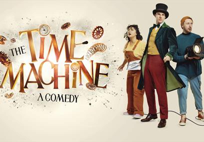 Three people stood in a V formation next to the words 'The Time Machine - a comedy'