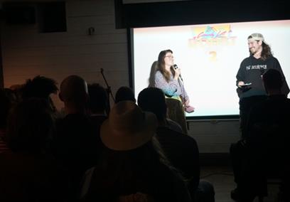 2 Comedians trading jokes with each other in front of a live audience