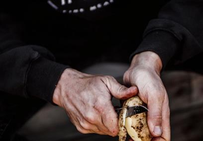 A man peeling a potato
