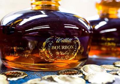 A close up picture of a willet bourbon bottle. The bottle is shaped like a pot still and full of bourbon.