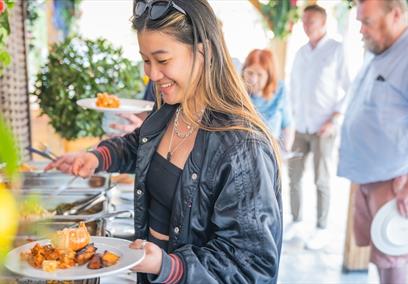 A women putting bbq food on a plate