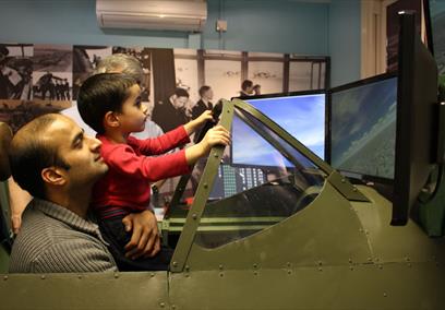 Maidenhead Heritage Centre: man and boy enjoying the Spitfire Simulator