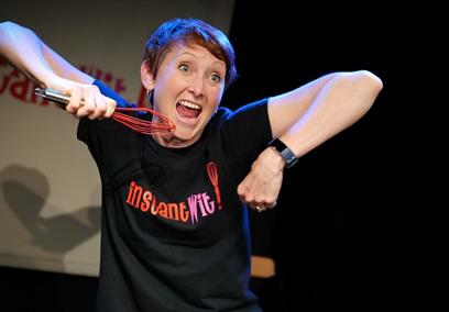 Woman on stage with whisk