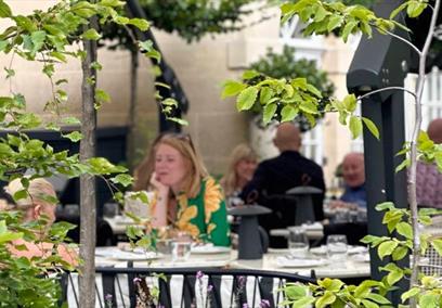 People sat in garden at hotel