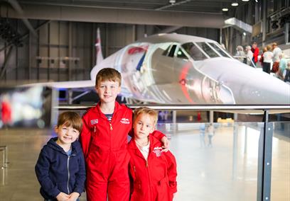 children in front of plane