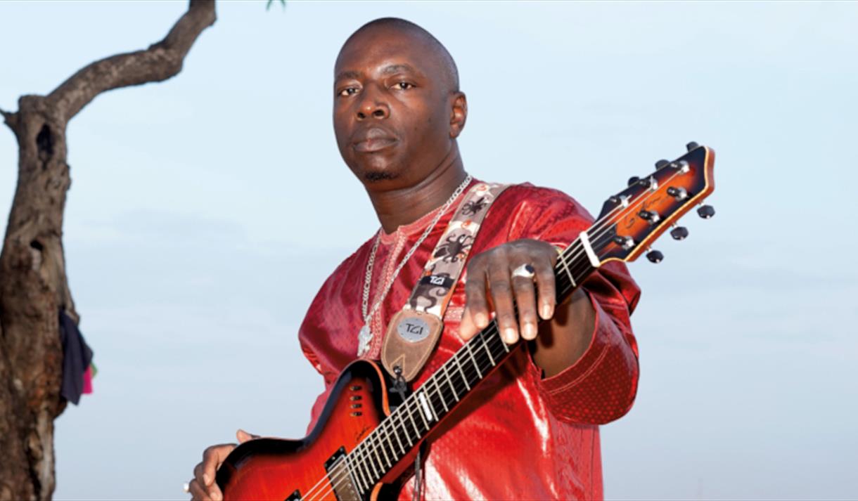 Vieux Farka Toure holding a guitar