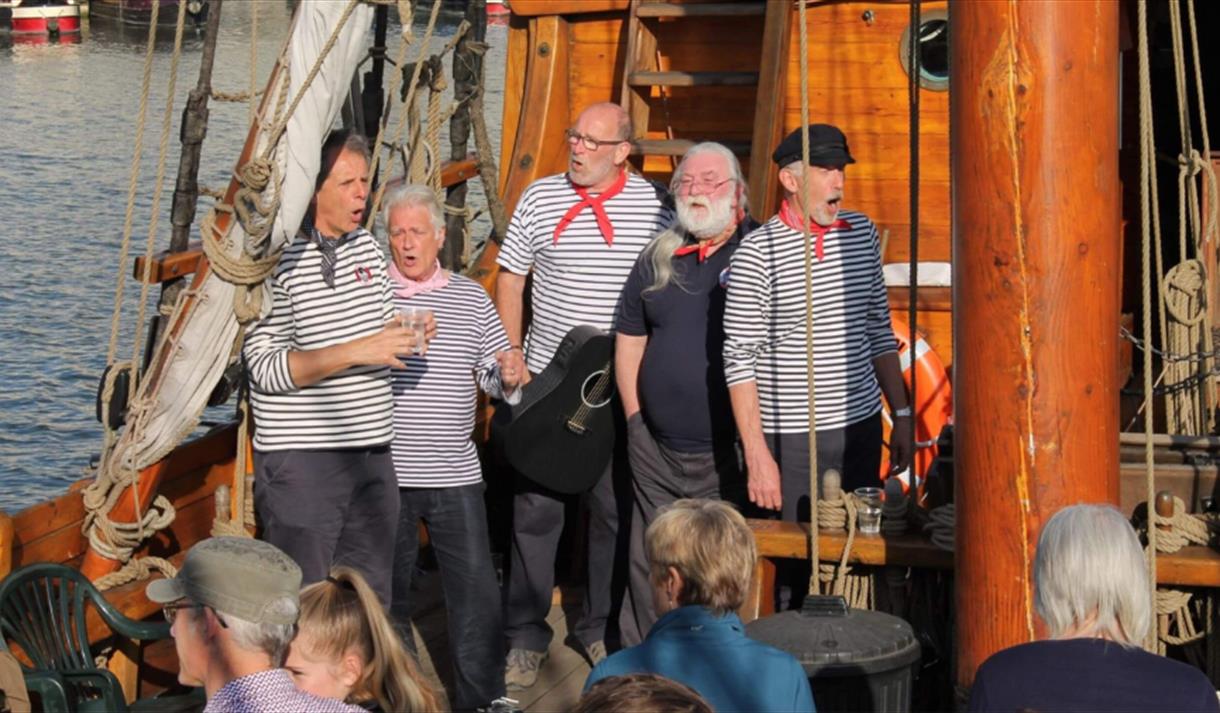 A group of singers performing on The Matthew