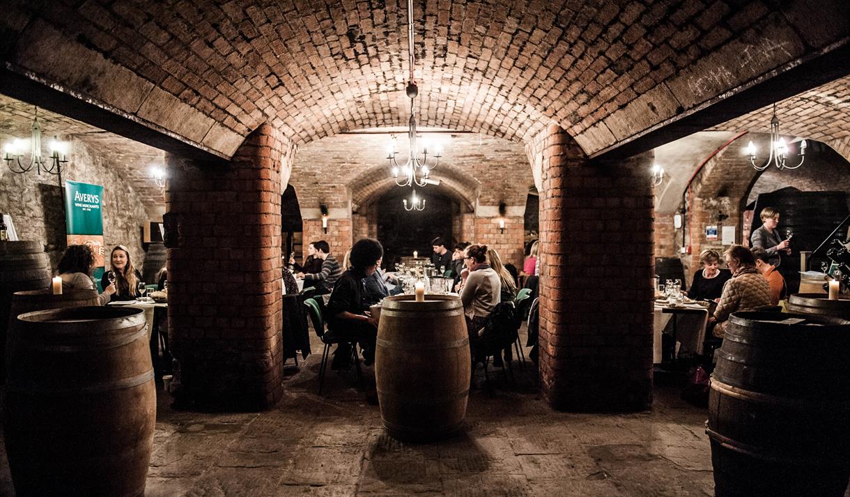 People dining in underground wine cellars