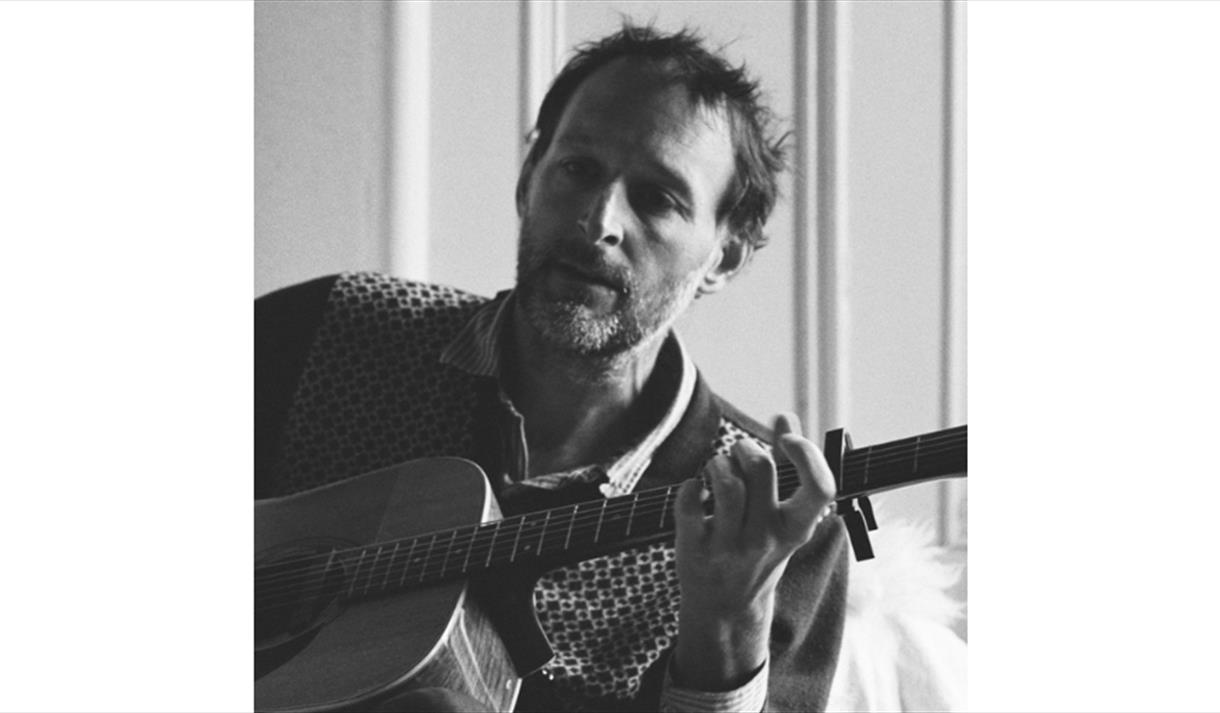 Alasdiar Roberts playing his guitar