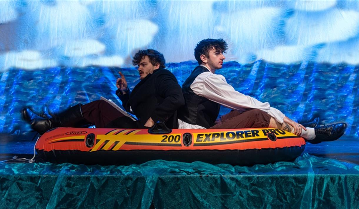 2 people in an inflatable life raft