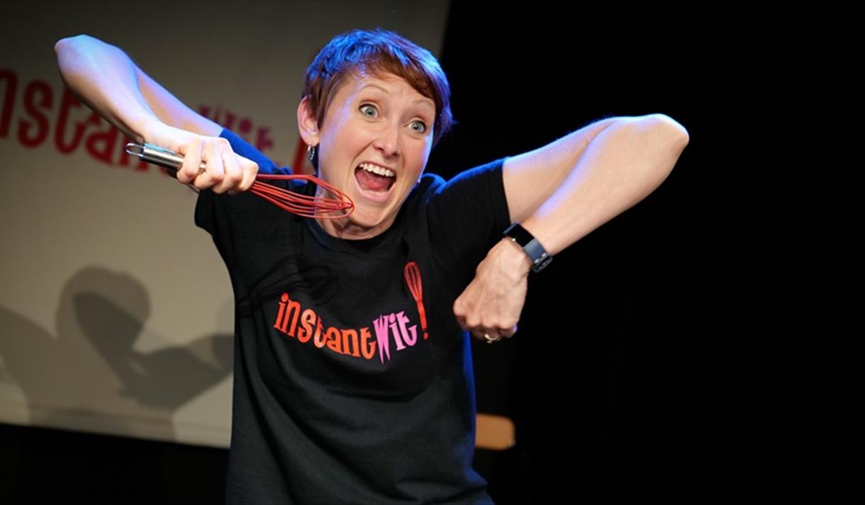 Woman on stage with whisk