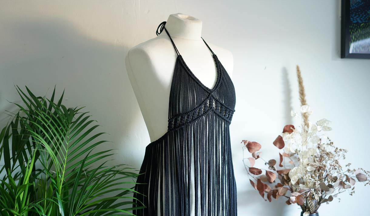 A black macrame dress on a mannequin