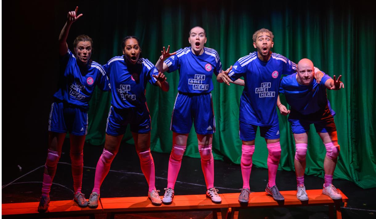 A group of peole wearing blue football kit