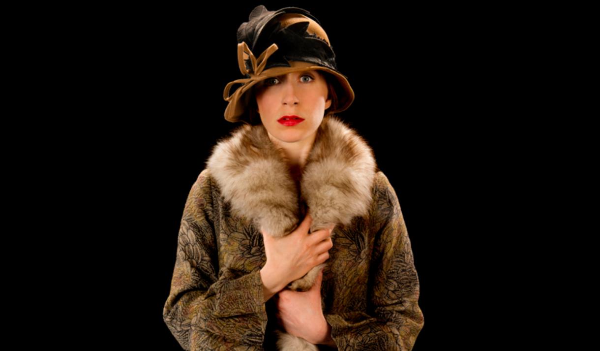 Woman in fur coat and hat costume for the show A Room of One's Own