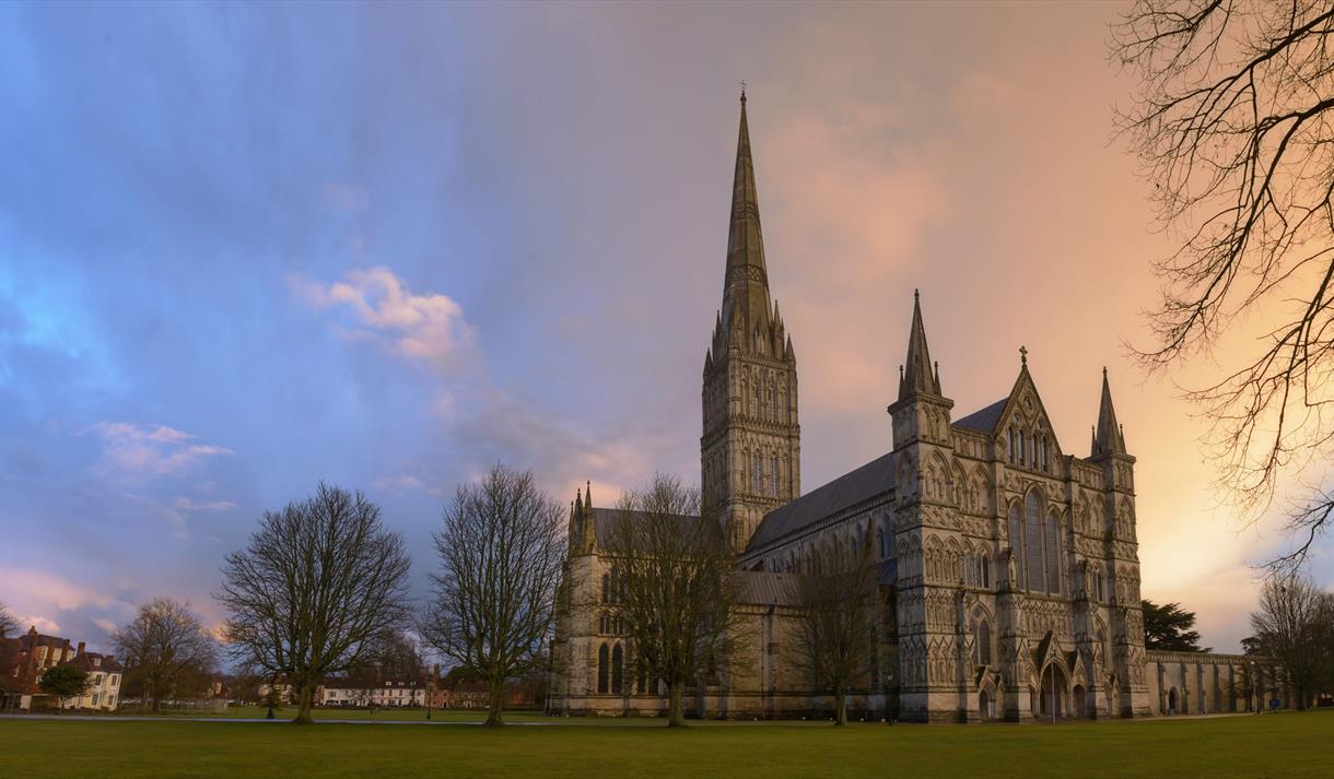 Setting sun behind salisbury cathedral