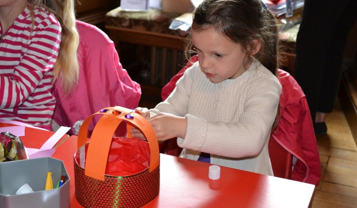 Little girl taking part in a craft activity at Windsor Castle