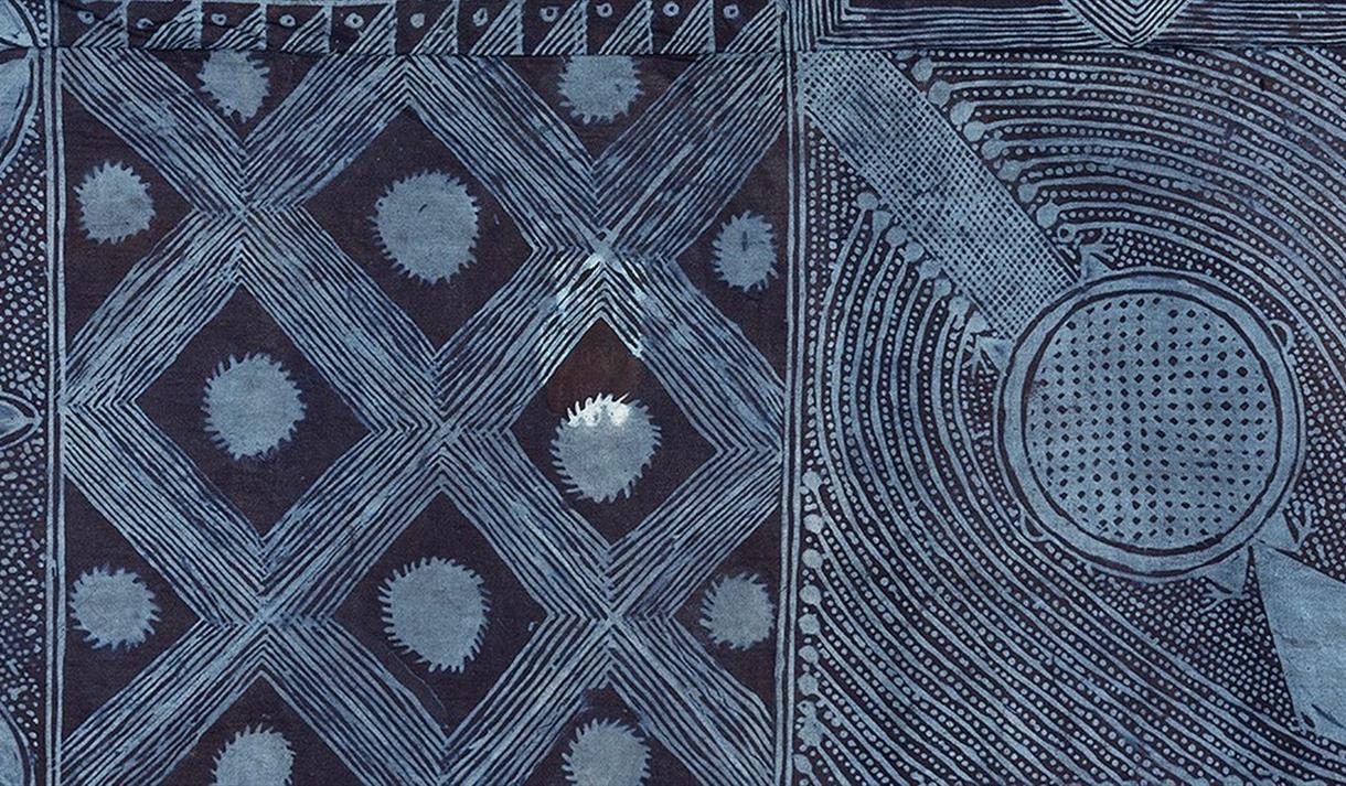 Close-up of a monochrome geometric artwork featuring intricate hand-drawn patterns in shades of dark blue and grey. The composition is divided into se